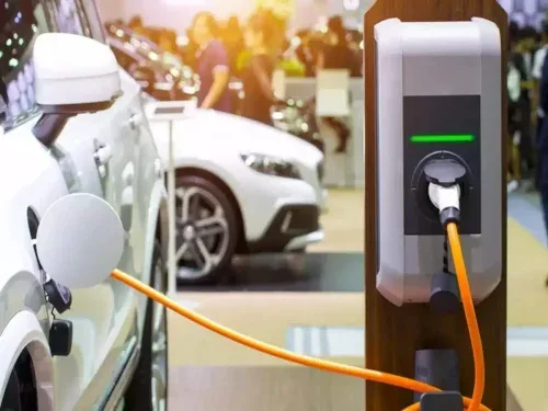 An electric vehicle charging at a charging station 500x375
